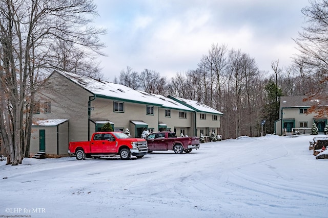 view of snow covered parking