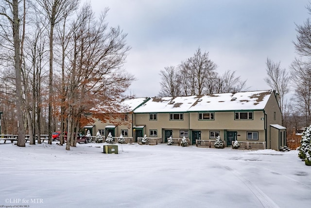 view of snow covered rear of property