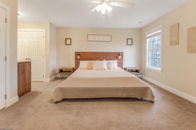 carpeted bedroom featuring ceiling fan and a closet