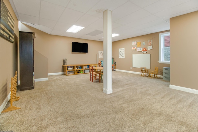 basement featuring carpet flooring and a drop ceiling