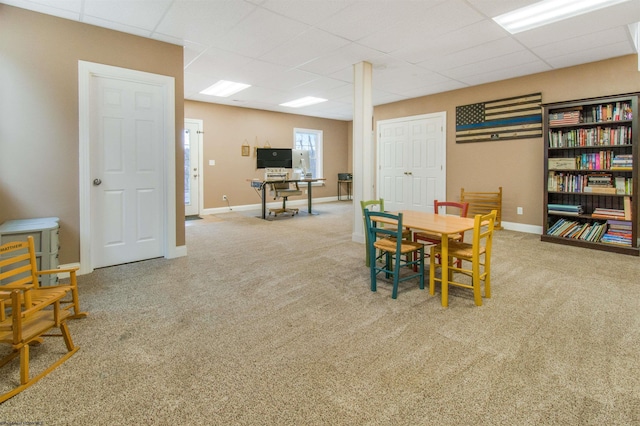 dining area featuring a drop ceiling and carpet floors