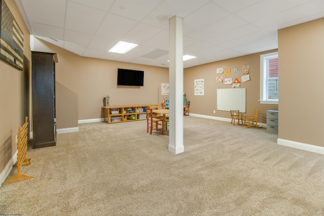 basement featuring carpet and a paneled ceiling