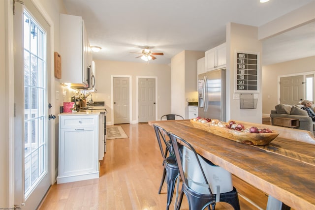 dining room featuring ceiling fan and light hardwood / wood-style floors