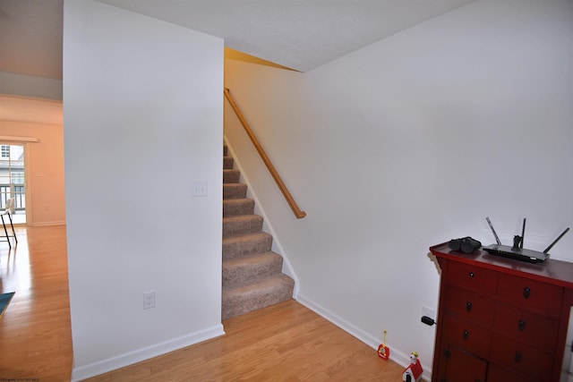 stairs with wood-type flooring