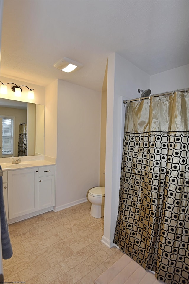 bathroom featuring vanity, toilet, and walk in shower