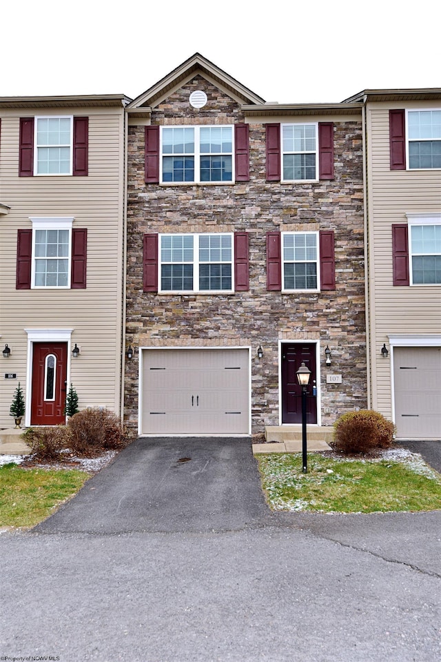 townhome / multi-family property featuring a garage