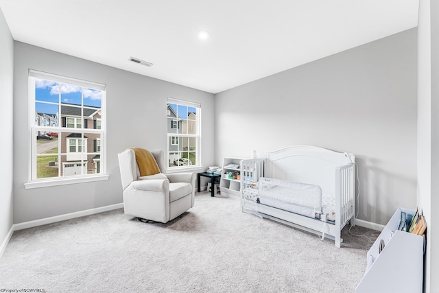 bedroom with carpet and a crib