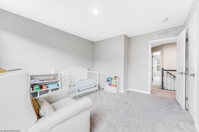 carpeted bedroom featuring a crib