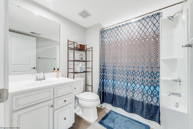 full bathroom featuring vanity, toilet, wood-type flooring, and shower / bath combo