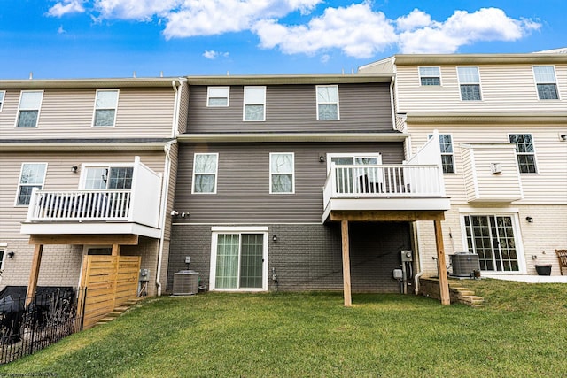 rear view of property featuring a yard and central AC