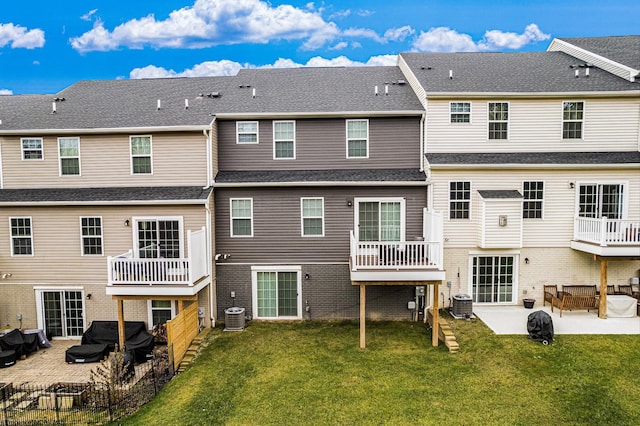 back of property featuring a patio, central AC, and a lawn