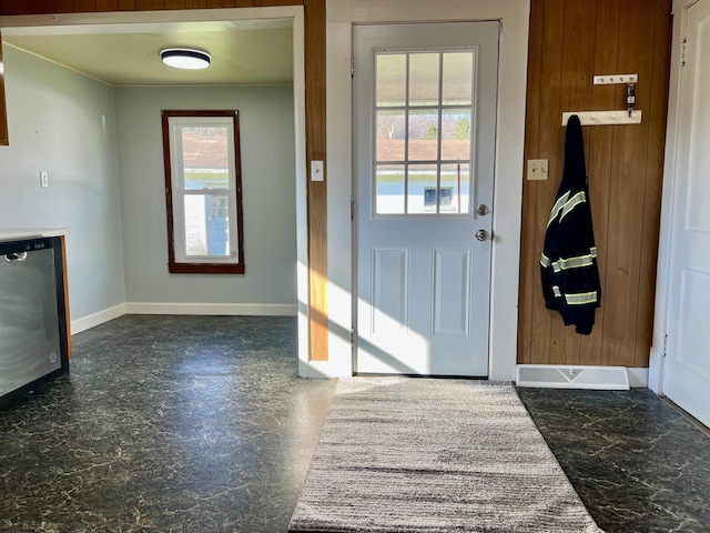 entryway featuring wooden walls