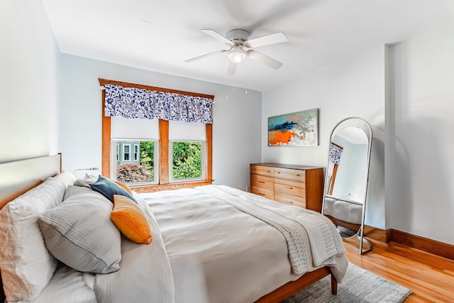 bedroom with ceiling fan and hardwood / wood-style floors