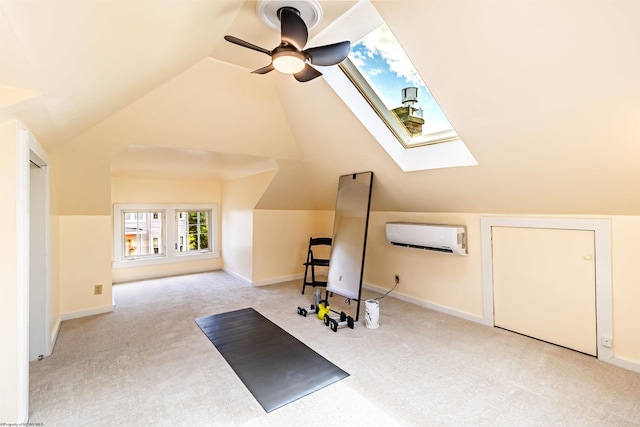 exercise room featuring lofted ceiling with skylight, ceiling fan, light colored carpet, and a wall mounted air conditioner