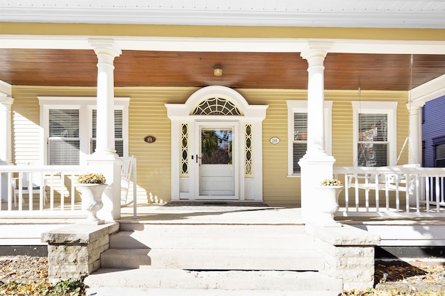 entrance to property featuring a porch