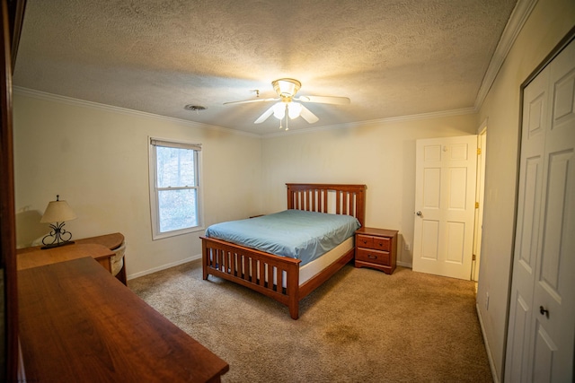 carpeted bedroom featuring a textured ceiling, ceiling fan, crown molding, and a closet