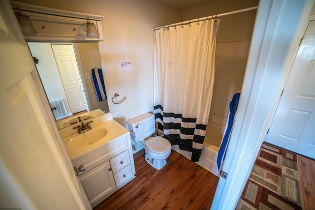 full bathroom with hardwood / wood-style floors, vanity, toilet, and shower / bath combo with shower curtain