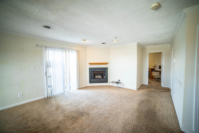 unfurnished living room featuring carpet, a textured ceiling, ornamental molding, and a tiled fireplace