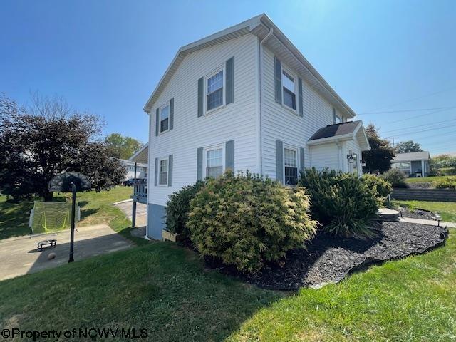 view of side of home with a lawn