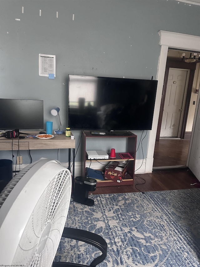 living area featuring baseboards and wood finished floors