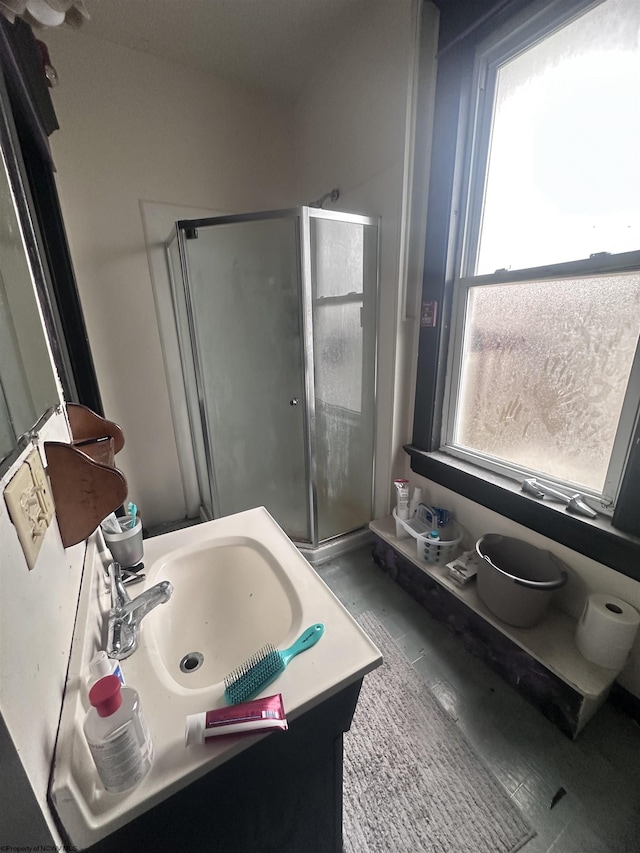 bathroom featuring vanity and a shower stall