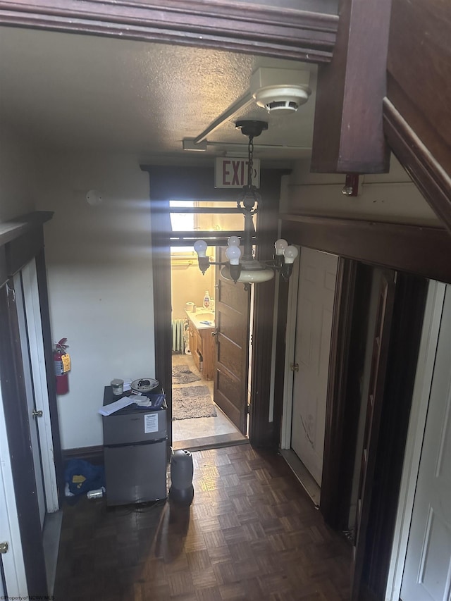 hallway featuring radiator and a textured ceiling