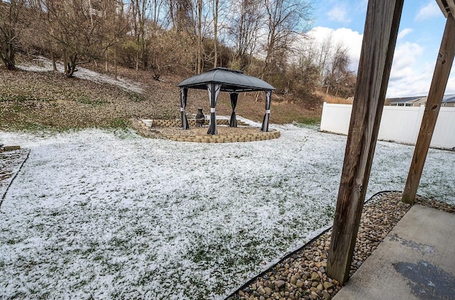 snowy yard featuring a gazebo