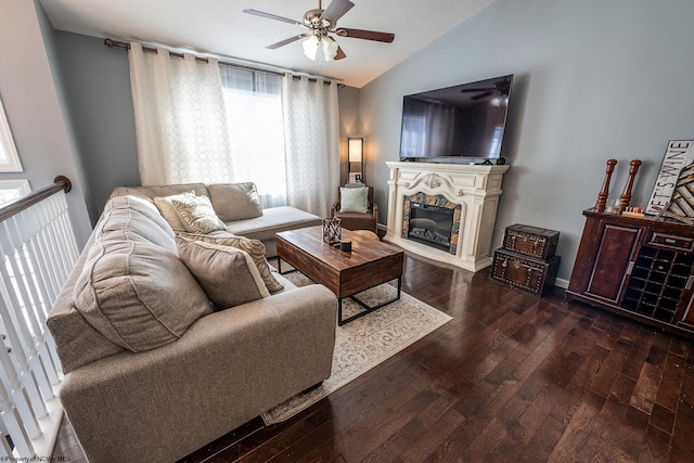 living room featuring ceiling fan, dark hardwood / wood-style floors, and vaulted ceiling