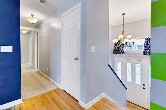 entrance foyer featuring a chandelier and wood-type flooring