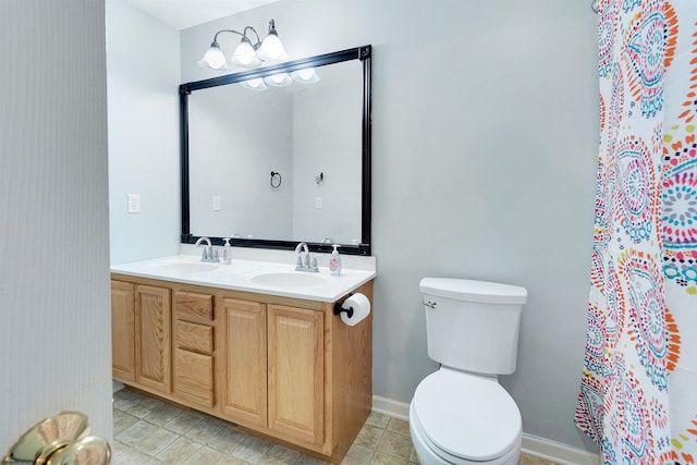 bathroom with tile patterned flooring, vanity, and toilet