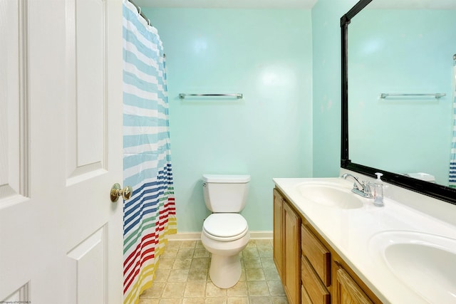 bathroom featuring tile patterned floors, vanity, curtained shower, and toilet