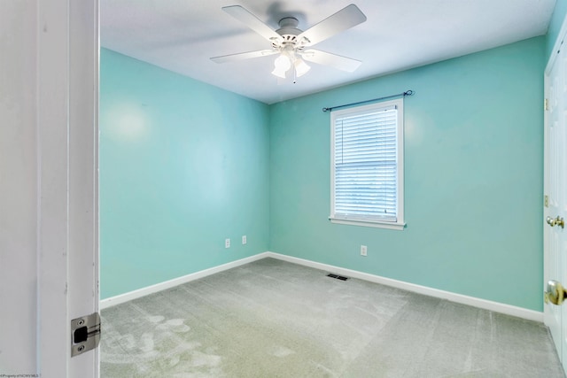 carpeted spare room with ceiling fan