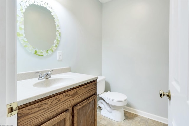 bathroom featuring tile patterned flooring, vanity, and toilet