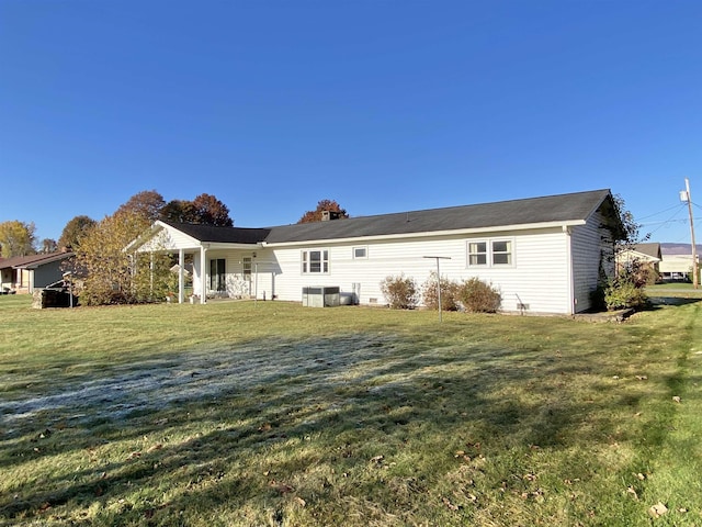 rear view of house with a yard