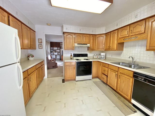 kitchen featuring sink and white appliances