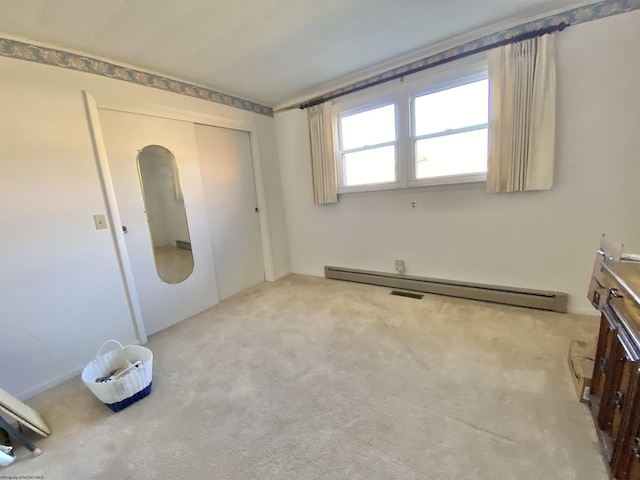 carpeted spare room with baseboard heating