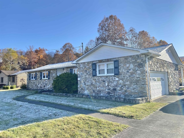 view of home's exterior with a yard and a garage