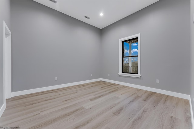 empty room with recessed lighting, visible vents, light wood finished floors, and baseboards