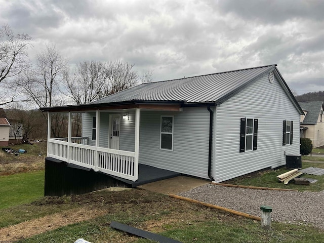 exterior space with a porch and central AC unit