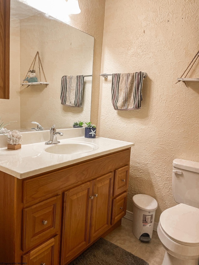 bathroom with tile patterned floors, vanity, and toilet