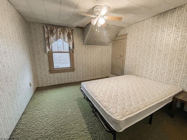 unfurnished bedroom with ceiling fan, lofted ceiling, and carpet floors