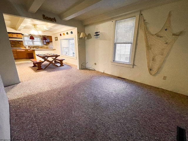 playroom featuring beamed ceiling, carpet, and ceiling fan