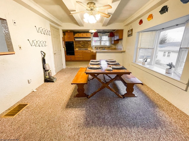 dining room with ceiling fan and light colored carpet