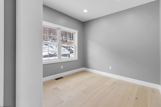 empty room with light hardwood / wood-style flooring