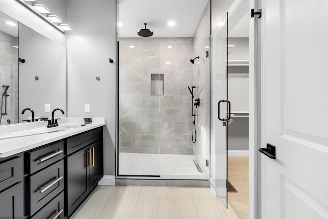 bathroom with an enclosed shower and vanity