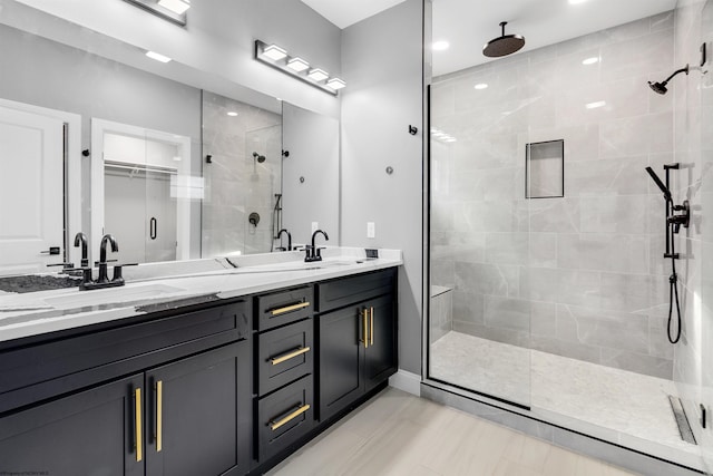 bathroom featuring vanity and a shower with shower door