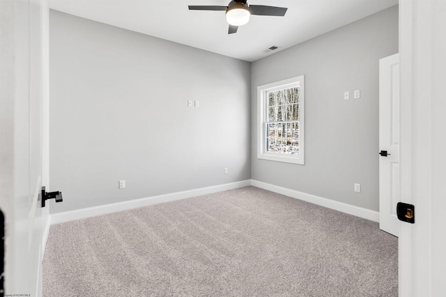 carpeted spare room with ceiling fan