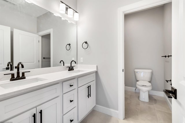 bathroom with vanity, tile patterned floors, and toilet