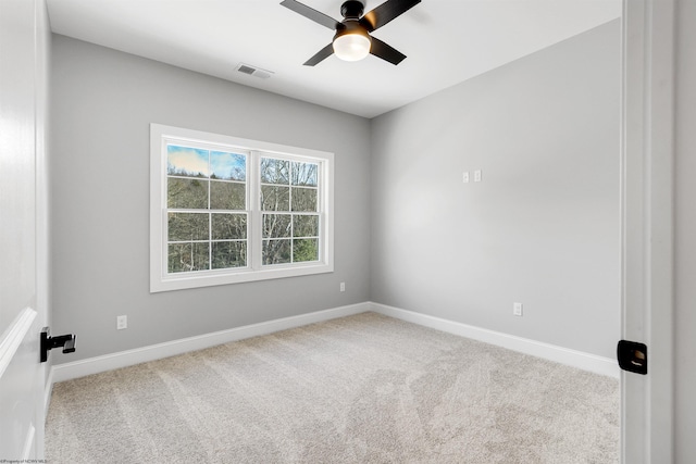 carpeted spare room featuring ceiling fan