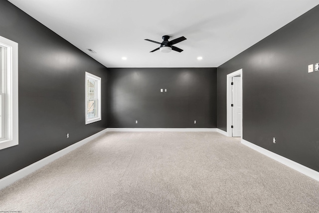 empty room with ceiling fan and carpet floors